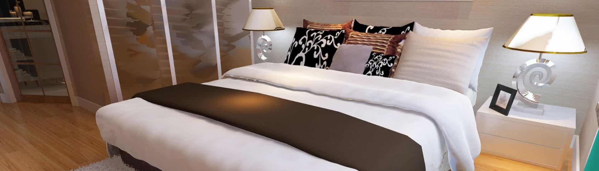 bed with white and brown linens