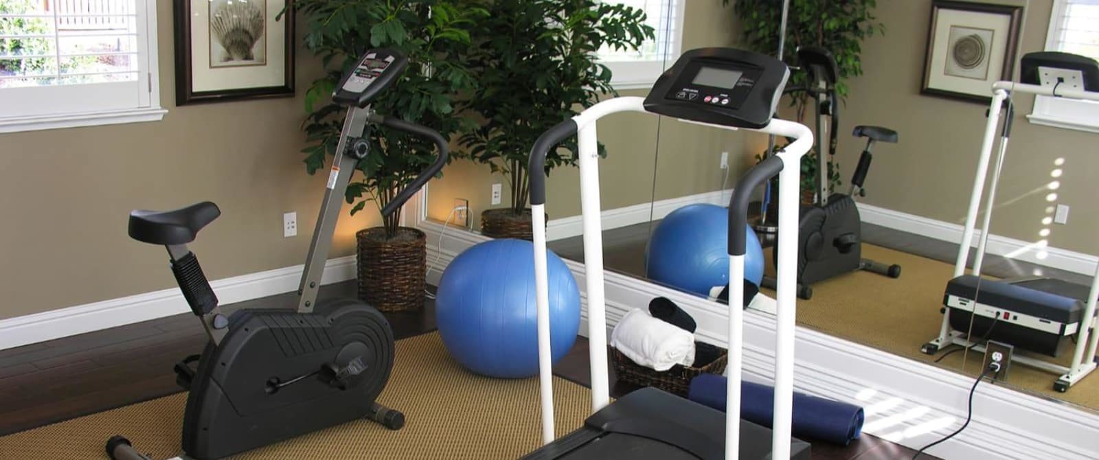 Room with stationary bike and treadmill